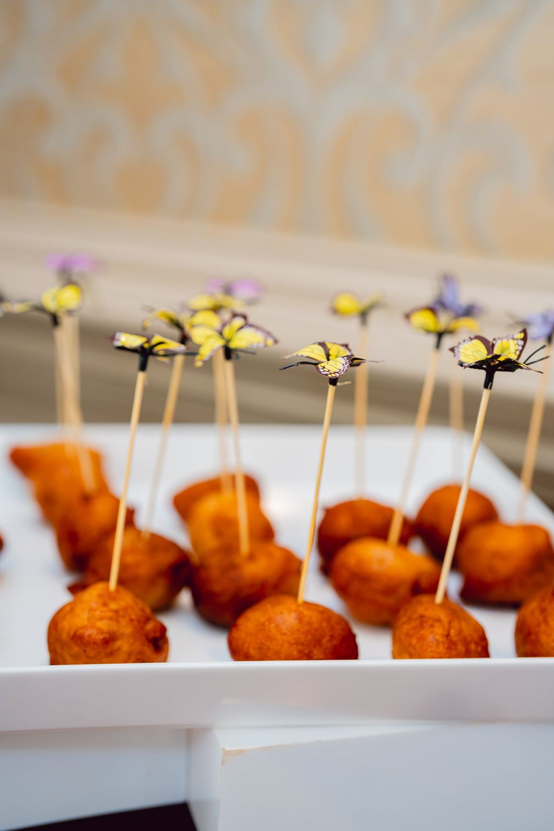 Puff puff canapés served with butterfly picks