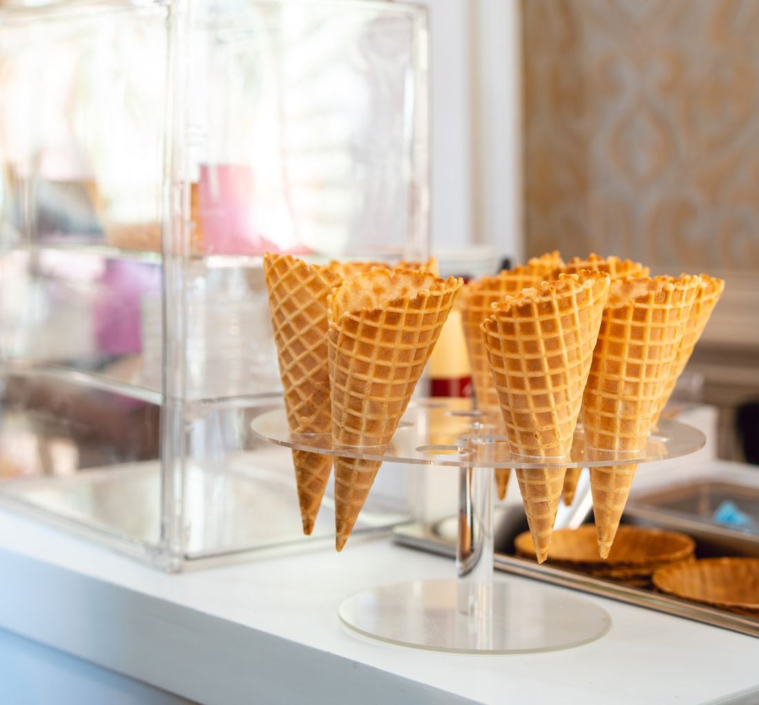 Waffle cones set out on an acrylic stand at the dessert station